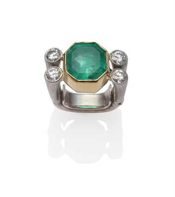 Lot 261 - A Contemporary Emerald and Diamond Ring, an emerald-cut emerald in a yellow collet setting, flanked