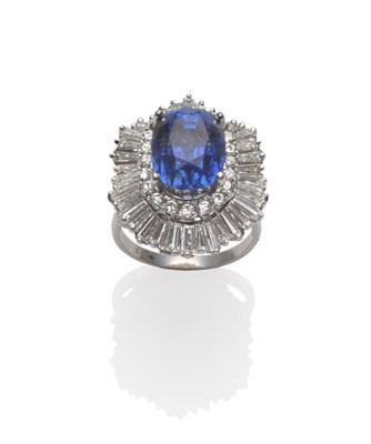 Lot 276 - A Sapphire and Diamond Cluster Ring-dant, the oval mixed cut sapphire within a border of round...