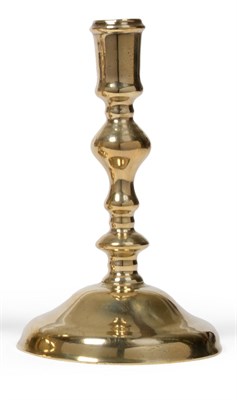 Lot 376 - A Late 17th Century Brass Candlestick, circa 1680, on a low domed foot with an inverted...