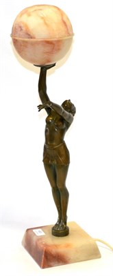 Lot 453 - A 1930's Art Deco Spelter Lamp, in the form of a female athlete holding aloft a two piece prize...