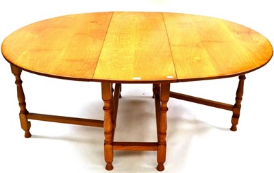 Lot 576 - An Albert "Eagleman " Jeffray Oak Gate Leg Table, the oval top on turned supports joined by...