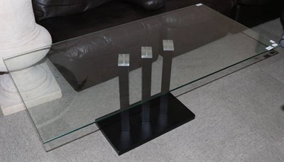 Lot 3016 - A Glass Top Coffee Table, modern, with rectangular top, raised on a black ash base, 120cm by...