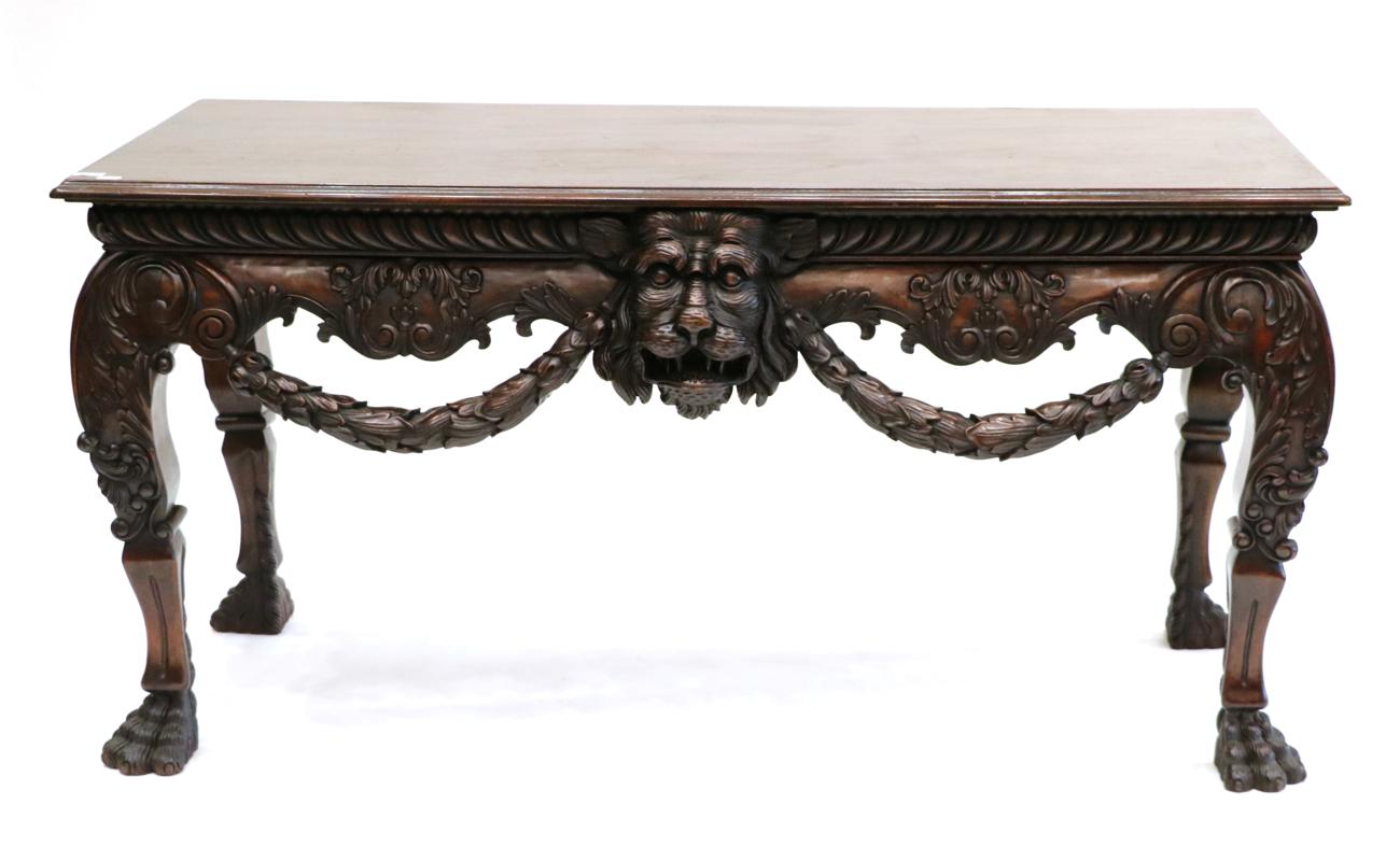 Lot 3019 - An Impressive Carved Hardwood Serving Table, modern, in George I style, with moulded top above...