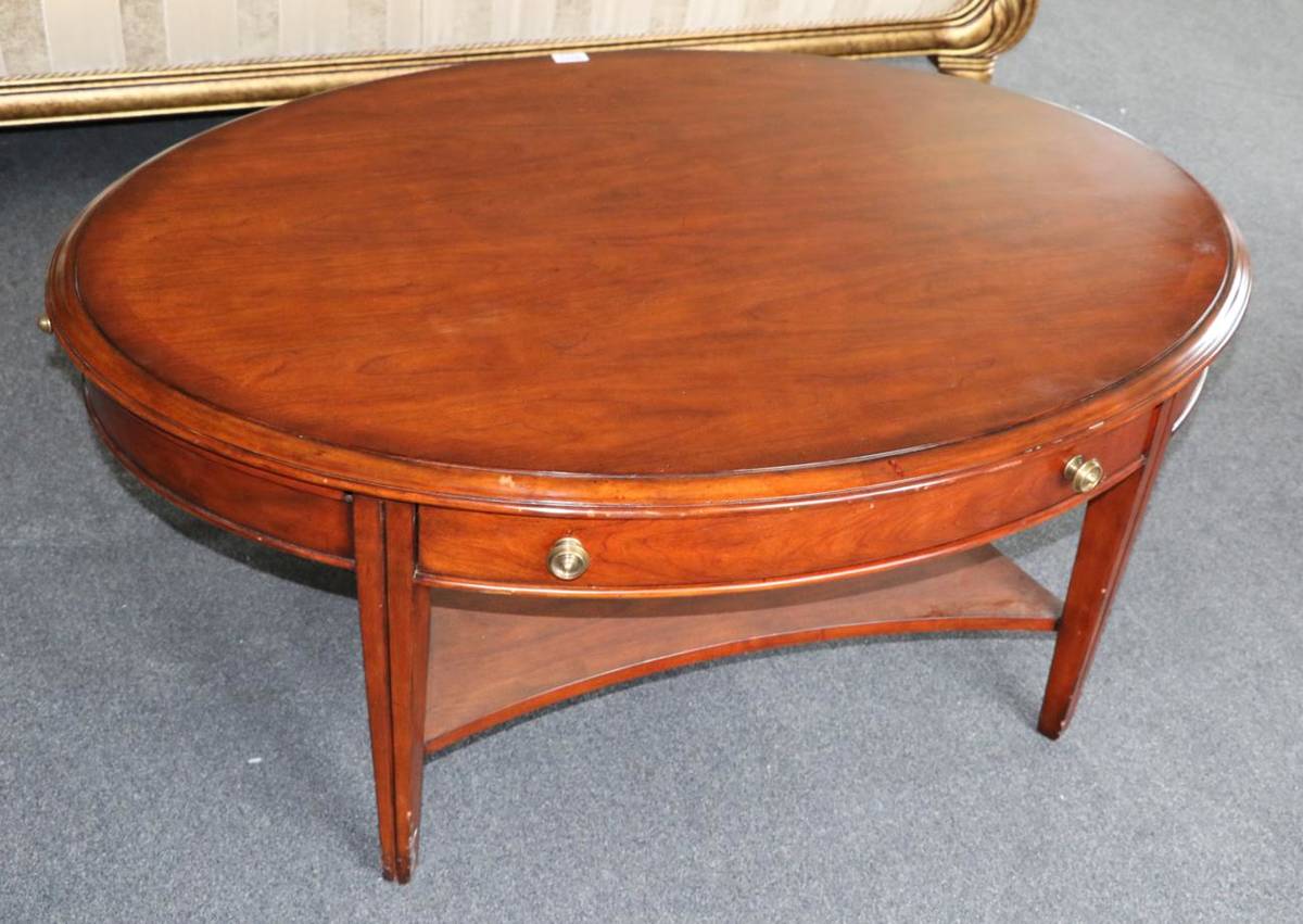 Lot 3021 - A Multiyork Mahogany and Crossbanded Coffee Table, modern, of oval form with two drawers, raised on