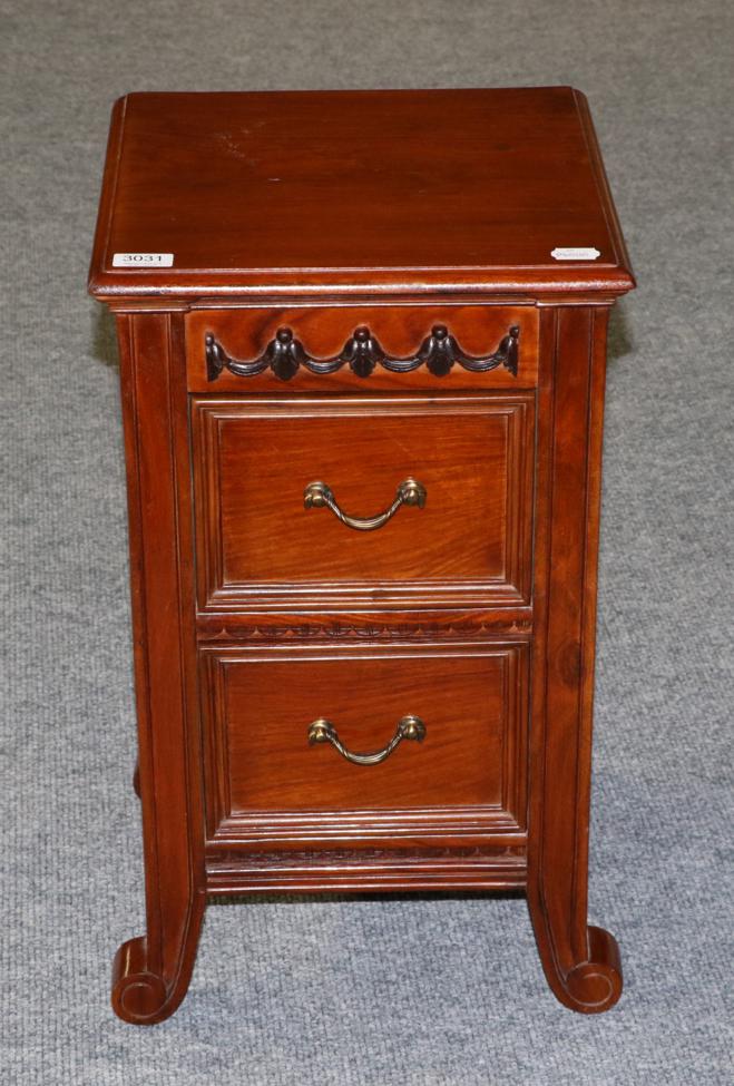 Lot 3031 - A Carved Hardwood Chest, modern, with two drawers above scrolled feet, 38cm by 34cm by 61cm
