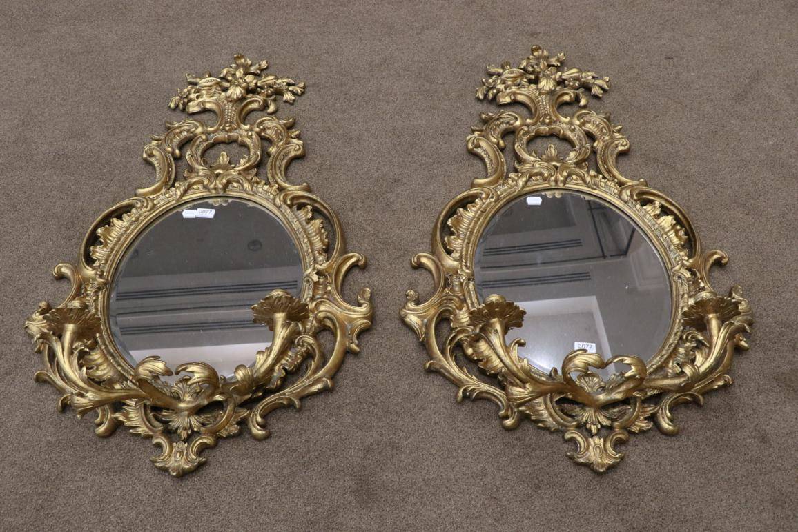 Lot 3077 - A Pair of Gilt Two-Branch Girandoles, modern, with oval mirror plates and scrolled frames...