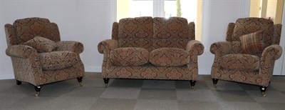 Lot 3119 - A Parker Knoll Oakham Model Three Piece Suite, modern, covered in multi-coloured floral fabric,...