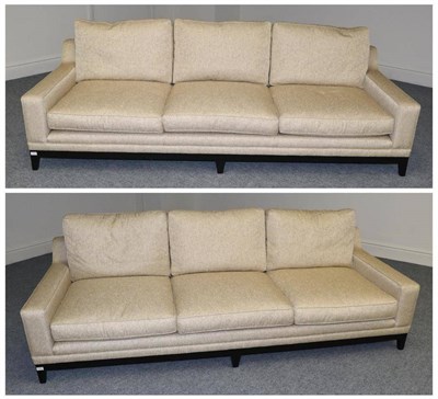 Lot 3134 - A Pair of Three-Seater Sofas, modern, upholstered in a shimmering gold effect fabric with...