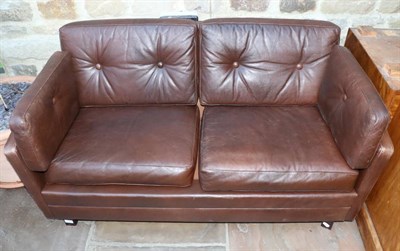 Lot 3170 - A 1970s Danish Design Two-Seater Sofa, upholstered in brown leather with six cushions and...
