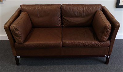 Lot 3174 - A 1970s Danish Design Two-Seater Sofa, upholstered in brown leather with six squab cushions and...