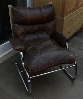 Lot 3175 - A 1970s Brown Leather and Chrome Tubular Framed Easy Chair, with padded back support, arms and...