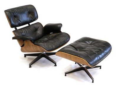 Lot 3188 - Charles and Ray Eames: A Brazilian Rosewood Lounge Chair and Ottoman, 1960s, the black leather...