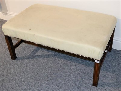 Lot 3190 - A Mahogany Framed Oversized Stool, modern, covered in beige close-nailed suede, with fluted and...