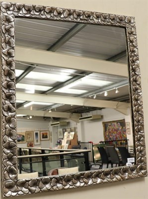 Lot 3193 - A Metal Framed Mirror, modern, stamped Garai Ghaderi 1000, the frame decorated as flower...