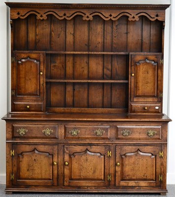 Lot 3002 - A Reproduction Oak Dresser and Rack, the upper section with two shelves flanked by fielded...