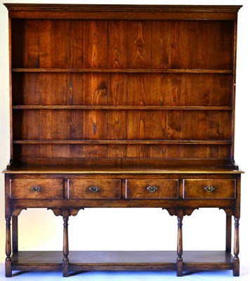 Lot 3006 - A Reproduction Oak Dresser and Rack, with three fixed shelves, the base of four frieze drawers...