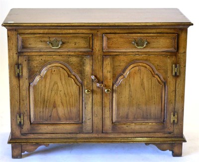 Lot 3009 - A Reproduction Oak Sideboard Dresser, with two frieze drawers above two fielded cupboard doors with