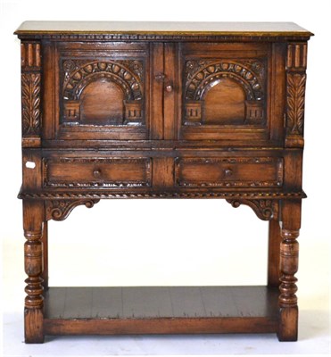 Lot 3017 - A Titchmarsh & Goodwin Carved Oak Cabinet, with two carved cupboard doors above two slides, two...