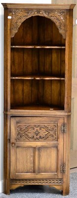 Lot 3018 - A Reproduction Oak Free-Standing Corner Cupboard, the upper section with two fixed shelves, the...