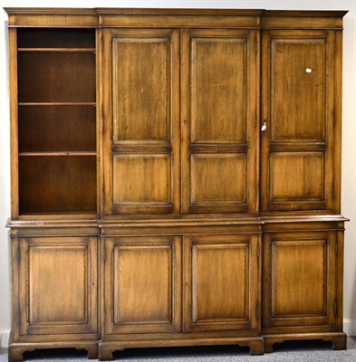 Lot 3019 - A Reproduction Oak Breakfront Bookcase, of recent date, the upper section with three cupboard doors