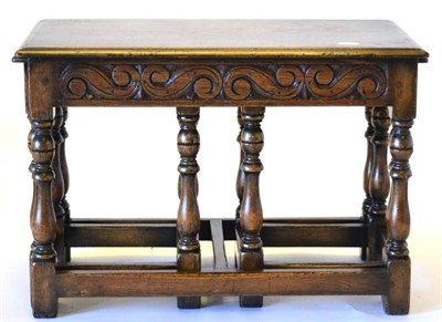 Lot 3022 - A Set of Three Reproduction Oak Nesting Tables, the largest of rectangular form with a carved...