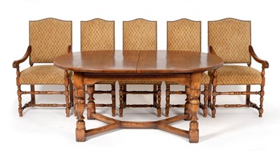 Lot 3028 - A Reproduction Oak Circular Extending Dining Table, with two additional leaves, raised on...