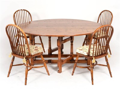 Lot 3033 - A Reproduction Brown Oak Six-to-Eight Seater Double Gateleg Dining Table, raised on gun barrel...