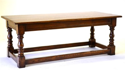 Lot 3037 - A Reproduction Oak Rectangular Coffee Table, raised on baluster turned legs joined by an H...