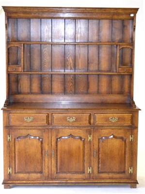 Lot 3038 - A Reproduction Oak Dresser and Rack, with two fixed shelves and two small drawers below two niches