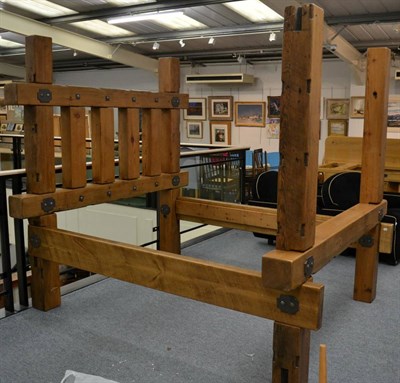 Lot 3047 - A Kingsize Bed, made of pine railway-style sleepers with metal fixing bolts and hammered metal...