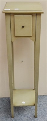 Lot 3049 - A Green Painted Plant Stand, of recent date, with a deep drawer and raised on square form legs...