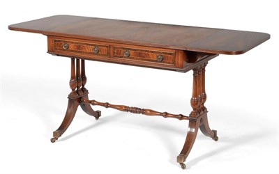 Lot 3060 - A Reproduction Mahogany and Crossbanded Sofa Table, with two rounded drop leaves and reeded...