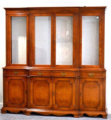 Lot 3064 - A Reproduction Yewwood Breakfront Display Cabinet, with an arcaded cornice above four astragal...