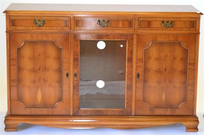 Lot 3068 - A Reproduction Yewwood Sideboard, with three frieze drawers above three cupboard doors, raised...