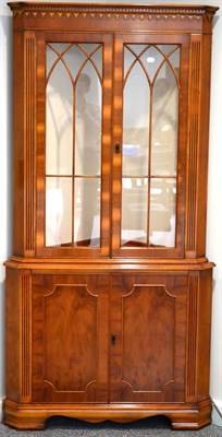Lot 3069 - A Reproduction Yewwood Free-Standing Corner Cabinet, the dentil and arcaded cornice above...