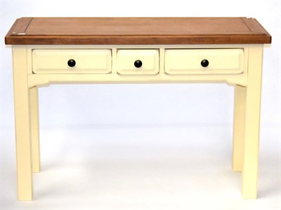 Lot 3084 - An Oak and Cream Painted Three Drawer Dressing Table or Hall Table, of recent date, with...