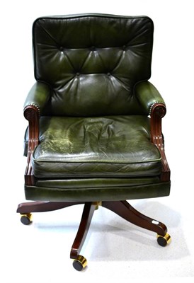 Lot 3087 - A Mahogany Framed Executive Office Swivel Armchair, upholstered in close-nailed green leather...