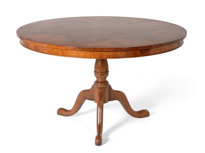 Lot 3091 - A Reproduction Burr Walnut Circular Dining Table, in George III style, raised on a baluster...