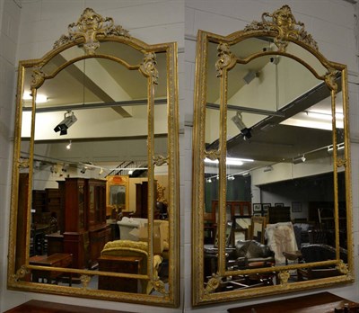 Lot 3132 - A Pair of Louis XV Style Gilt and Gesso Mirrors, with a moulded flower decorated frame...