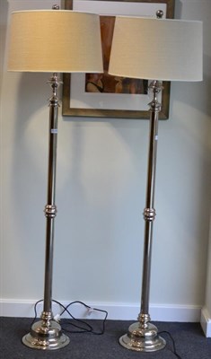 Lot 3148 - A Pair of Chromed Standard Lamps, of recent date, with cream shades, column supports and...