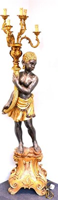 Lot 801 - An Italian Carved, Gilded and Painted Blackamoor Standard Lamp, the downward gazing figure...