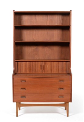 Lot 3169 - A 1970s Danish Teak Bookcase, the top section with two adjustable shelves above a tambour front...