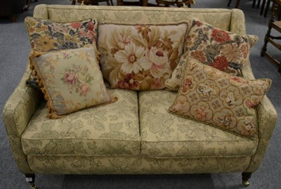 Lot 3181 - A Two-Seater Sofa, of recent date, covered in pale cream and green floral pattern fabric, with...