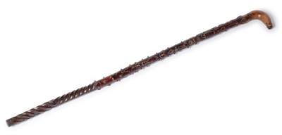 Lot 806 - An Unusual Carved and Stained Wood Walking Stick, late 19th century, naively carved with...