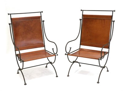 Lot 3195 - A Pair of Scrolled Metal Armchairs, with tubular frames and brown hide seats, 68cm wide