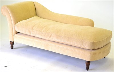 Lot 3198 - A Reproduction Chaise Longue, upholstered in yellow plush velvet with rounded back support...