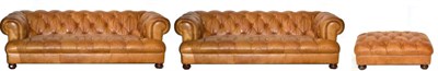 Lot 3200 - A Pair of Brown Leather Button Back Chesterfield Style Sofas, of recent date, retailed by John...