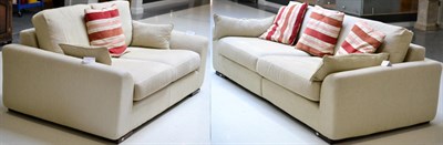 Lot 3211 - A Pair of Cream Upholstered Sofas, of recent date, comprising a three-seater sofa with squab...