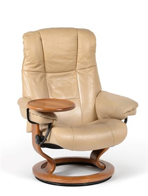 Lot 3213 - An Ekornes Stressless Beige Leather Swivel and Reclining Chair, with circular oak effect...