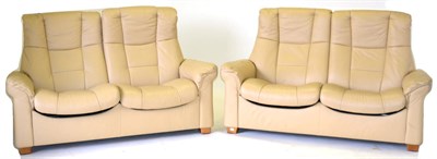 Lot 3214 - A Pair of Ekornes Stressless Cream Leather Two-Seater Reclining Armchairs, raised on square...